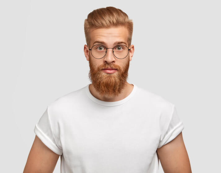 Confident Ginger Man With Trendy Hairstyle Wears Spectacles Looks Directly 1 1